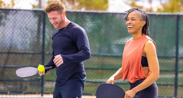 Man and woman playing pickleball